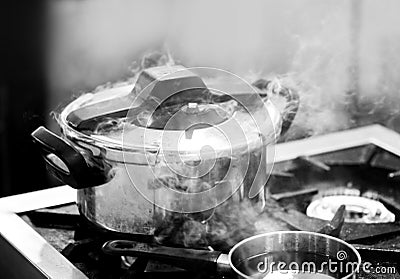 Pressure cooker steam over cooking in a Kitchen Stock Photo