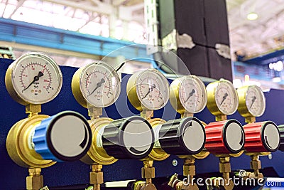 Pressure gauges with adjustment valves in industrial plant shop. Oxygen supply. Stock Photo