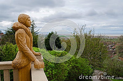 Chainsaw sculpture of a woman looking to the sea Editorial Stock Photo