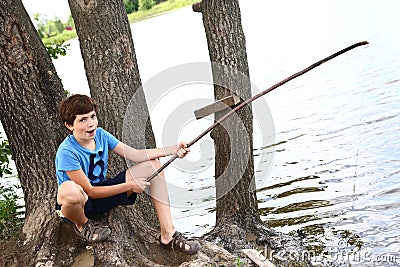 Preteen boy with fishing self made rode Stock Photo