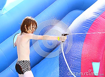 Preteen boy in swimming slip shoot water Stock Photo