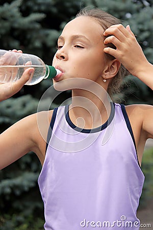 Preteen girl drinking watter Stock Photo