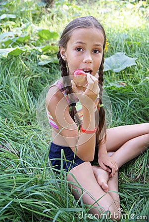 Preteen girl eatting apple Stock Photo