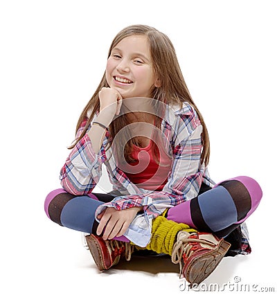 Preteen girl sitting cross-legged on the floor Stock Photo