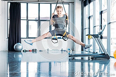 Preteen girl training with resistance bands in fitness class Stock Photo