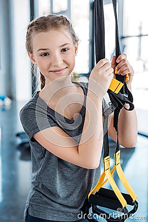 Preteen girl training with resistance bands in fitness class Stock Photo