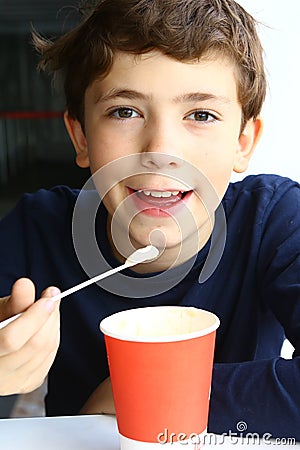 Preteen handsome boy with cappuccino paper glass Stock Photo