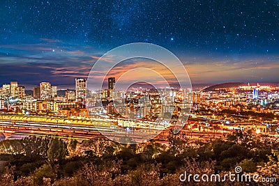 Pretoria city lit up at night with twilight and stars in the sky Stock Photo