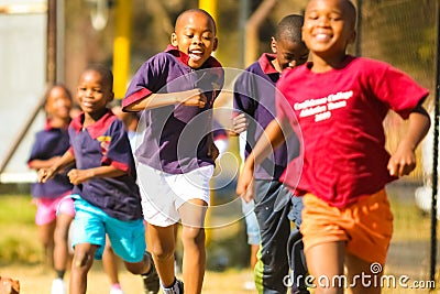 Diverse African Primary School children doing physical exercise PT lesson Editorial Stock Photo