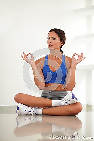 Pretty adult woman exercising in yoga class Stock Photo