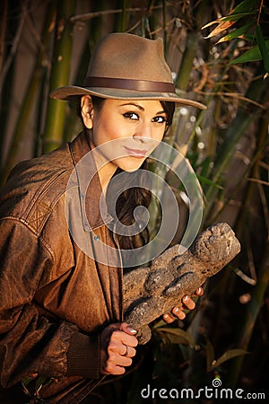 Pretty adventurer with stolen relic Stock Photo