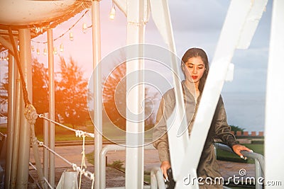 Pretty Asian female soldier walking relax on a ship. Stock Photo