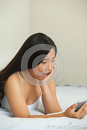 Pretty asian surprised by text message Stock Photo