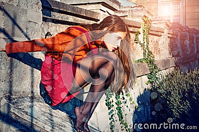 Pretty Autumn woman in skirt and stockings sit stairs architecture background. Fashion concept. Youth fashion. Enjoy Stock Photo