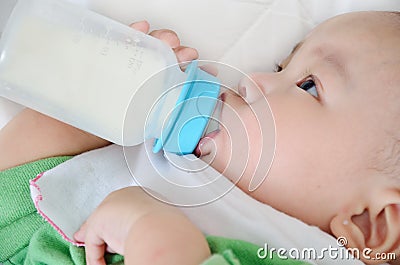 Pretty baby boy drinking milk from bottle Stock Photo