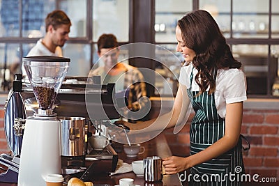 Pretty barista making a cup of coffee Stock Photo