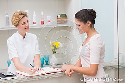Pretty beautician talking with client Stock Photo