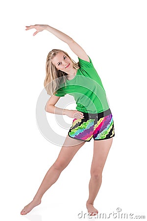 Pretty blond woman wearing in sportswear lunging and tilting to the side with hand above a head Stock Photo