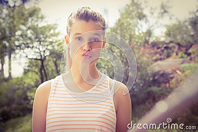 Pretty blonde sending kiss and taking selfies with selfiestick Stock Photo