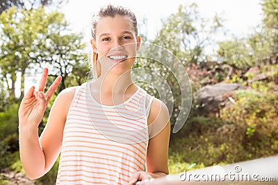 Pretty blonde showing peace sign and taking selfies Stock Photo