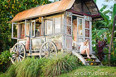 Pretty blonde woman and antique gypsy caravan 6 Stock Photo