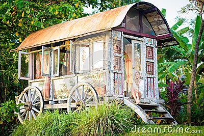 Pretty blonde woman and antique gypsy caravan 8 Stock Photo