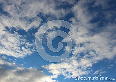 Pretty blue skies after dawn with white puffy clouds opening up for the sunny day ahead Stock Photo