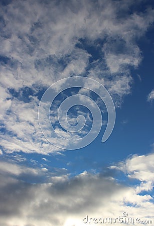 Pretty blue skies and puffy clouds moving out of the way for sunny day ahead Stock Photo