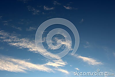 Pretty blue skies with trail of wispy clouds moving across the surface Stock Photo