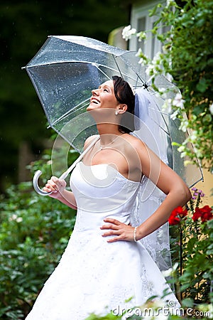 Pretty bride in rain Stock Photo