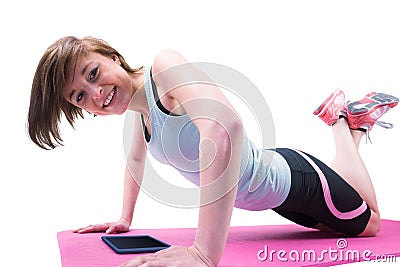 Pretty brunette doing press up on fitness mat Stock Photo