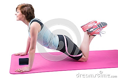 Pretty brunette doing press up on fitness mat Stock Photo