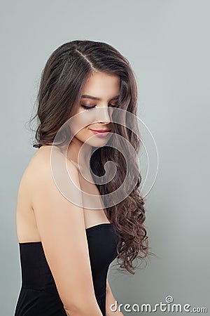 Pretty brunette model woman with long curly brown hair and natural makeup Stock Photo