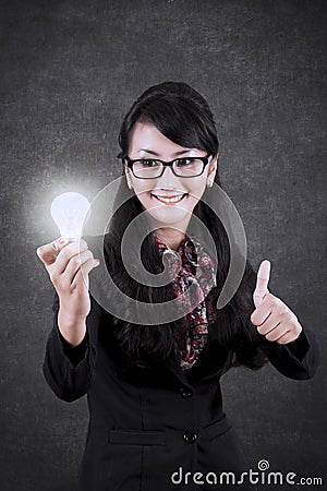 Pretty businesswoman with bright bulb Stock Photo