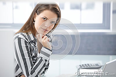 Pretty businesswoman at desk Stock Photo