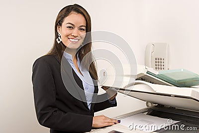 Pretty businesswoman making copies Stock Photo