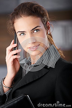 Pretty businesswoman talking on mobile smiling Stock Photo