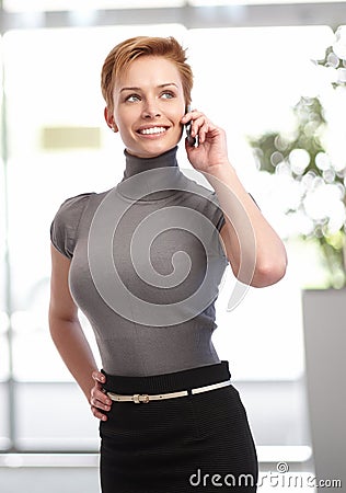 Pretty businesswoman talking on mobile Stock Photo