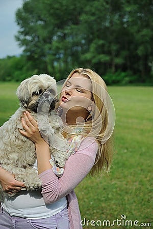 Pretty casual woman with cute little dog outdoors Stock Photo