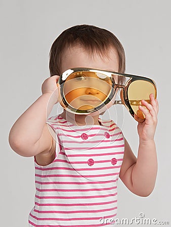 Pretty child with giant sunglasses Stock Photo