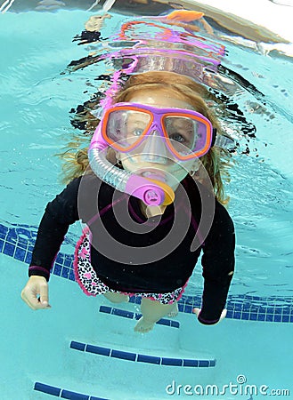 Pretty child swimming in pool Stock Photo