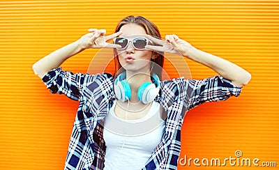 Pretty cool girl in sunglasses and headphones having fun Stock Photo