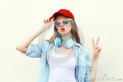 Pretty cool woman in sunglasses and red cap over white Stock Photo