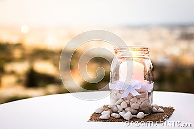 Pretty decorated candle table ornament with bright light. Stock Photo