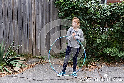 Little girl standing with hula hoop Stock Photo