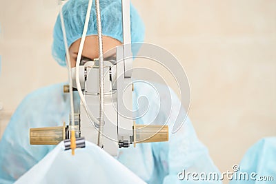 Pretty doctor woman portrait. Ophthalmology laser microscope operation. Clinic room. Patient eye treatment Stock Photo