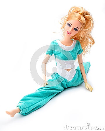 A pretty doll sitting in the pose of twine stretched legs to the side Editorial Stock Photo