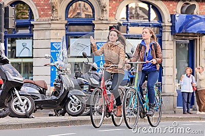 Pretty Dutch girls on a bike, Amsterdam, Netherlands Editorial Stock Photo