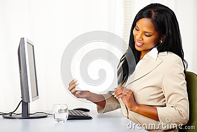 Pretty executive female showing a white card Stock Photo