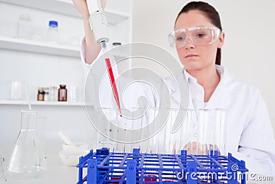 Pretty female biologist holding a manual pipette Stock Photo
